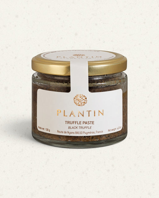 Glass jar of Plantin black truffle paste with a gold lid and white label, dark paste visible inside