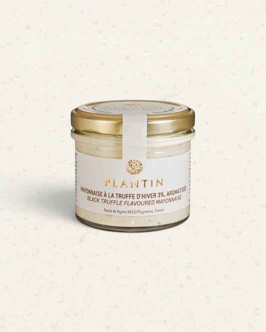 Glass jar of Plantin black truffle mayonnaise with a gold lid and white label, pale mayonnaise inside