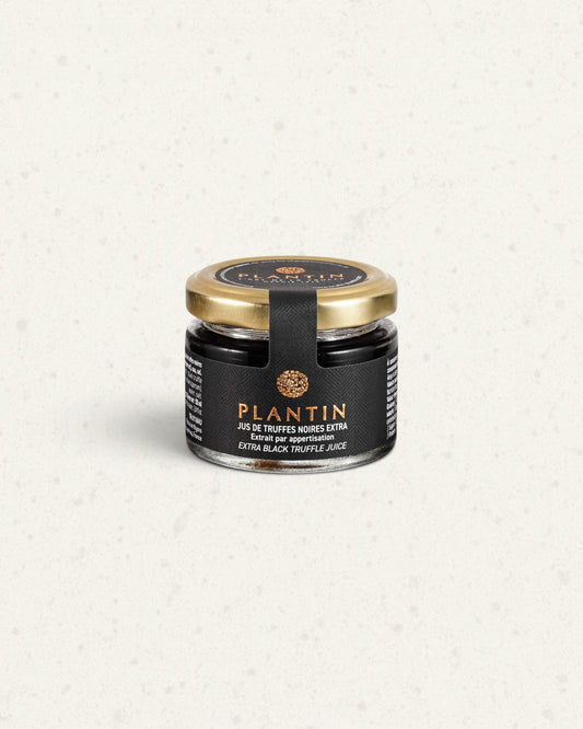 Small glass jar of Plantin extra black truffle juice with a gold lid and a black label