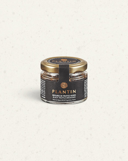 Small glass jar of Plantin black truffle breakings with a gold lid and a black label